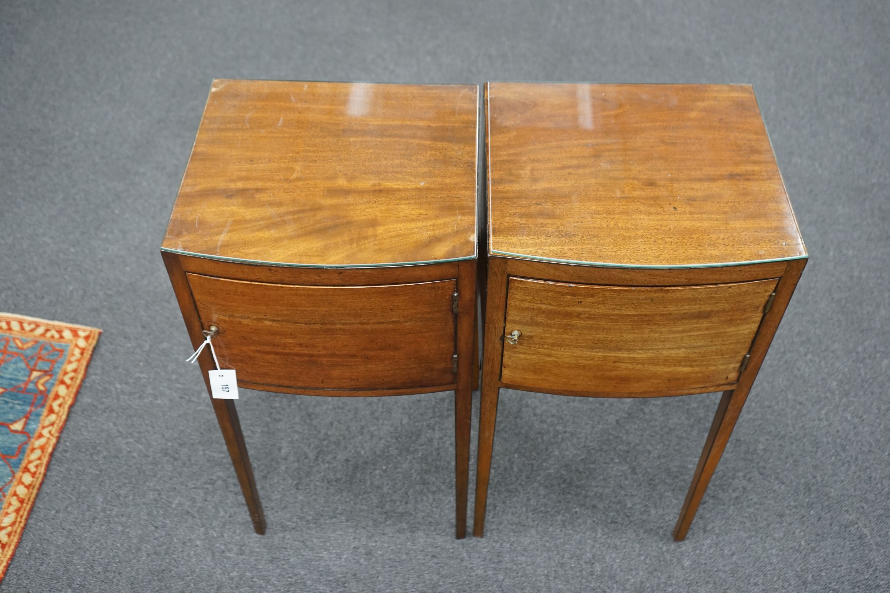 A pair of George III style mahogany bow front bedside cabinets, width 38cm, depth 36cm, height 76cm